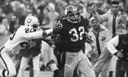 Franco Harris eludes Oakland Raiders’ Jimmy Warren after making the ‘Immaculate Reception’ in a playoff game in 1972.
