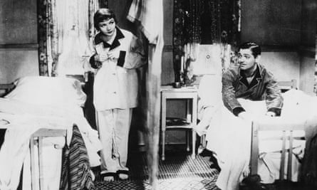 Claudette Colbert and Clark Gable in It Happened One Night in the bedroom scene in which they are separated by a sheet hung as a screen