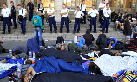 Hungarian police watch over migrants outside Keleti station in Budapest, Hungary.