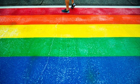 A pedestrian walks on a rainbow-colored crosswalk for Pride Week in Seattle in 2015.