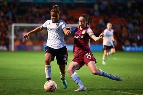 Nikita Parris is challenged by Danielle Turner of Aston Villa.