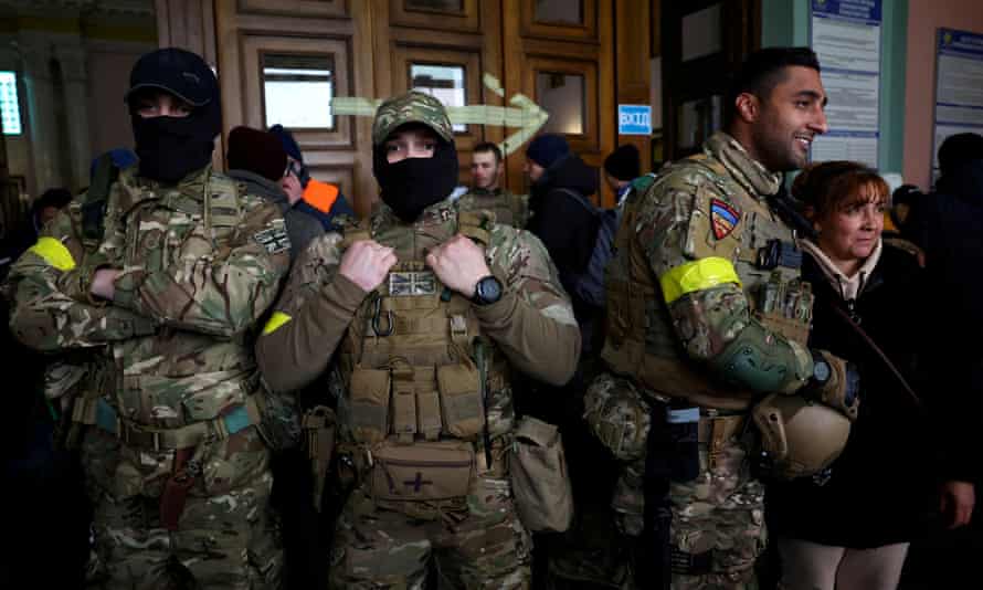 Ben Grant (right) and other foreign fighters from the UK posing for a picture as they prepared to depart for Ukraine on 5 March.