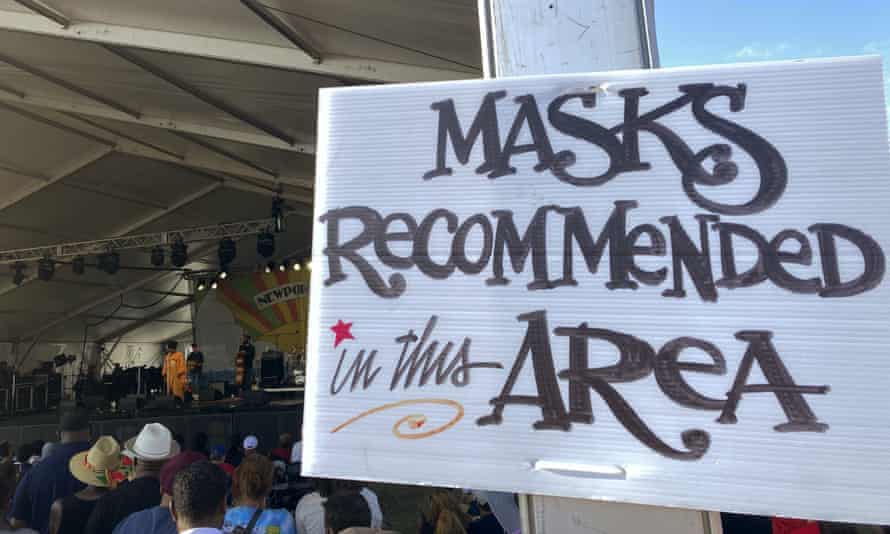 A sign recommends attendees of the Newport Jazz Festival wear masks in a tented area where singer Ledisi performs