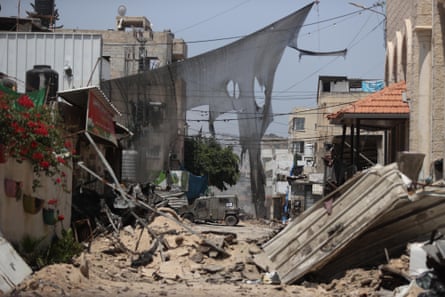 An armoured vehicle passes through the rubble of Jenin refugee camp.