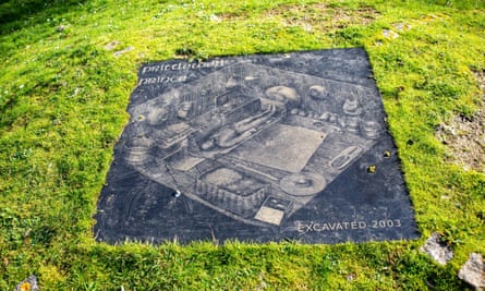 Stone set into the grass showing what the grave inside would have looked like