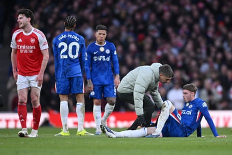 Chelsea's Cole Palmer receives medical attention after sustaining an injury.