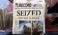 A stack of the latest weekly edition of the Marion County Record with headline seized but not silenced