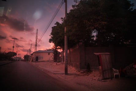 Sunset on a quiet road in Mogadishu, with a sentry post outside a compound in the foreground
