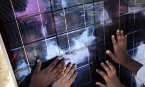 Children touch a solar panel