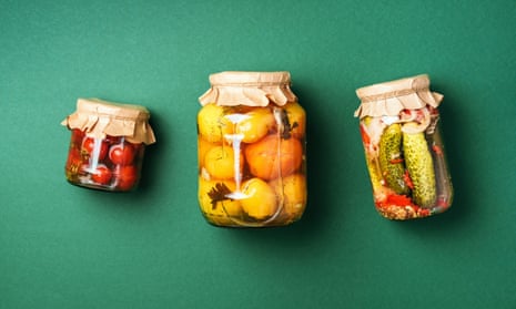 cucumber, squash and tomatoes pickling in glass jars