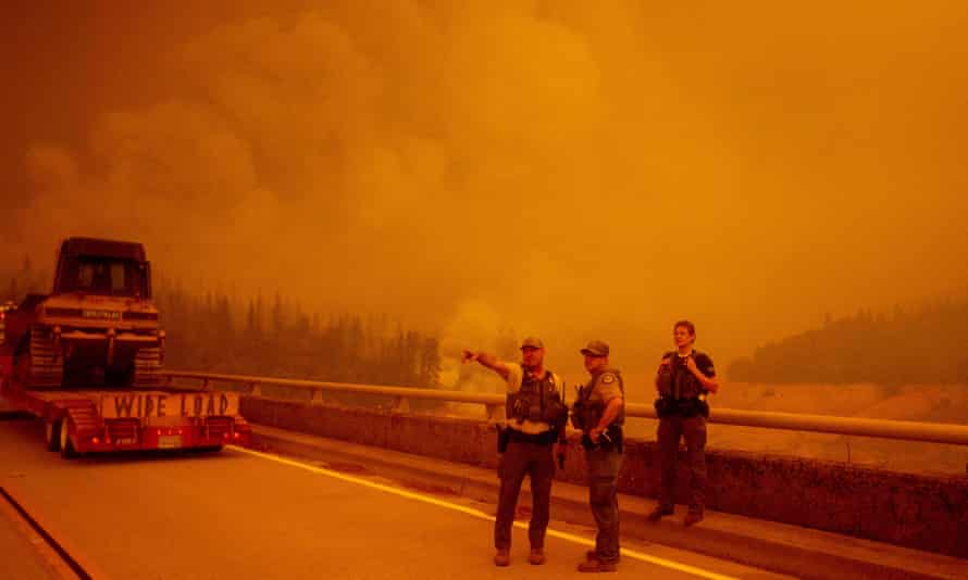 Law enforcement and fire personnel wait to enter an area encroached by flames during the Bear fire, in Oroville, California, in September 2020.