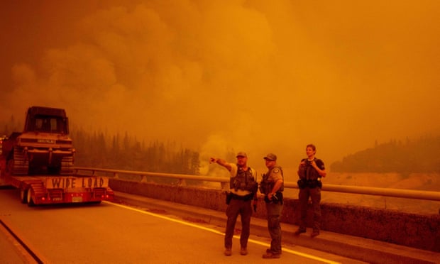 Law enforcement and fire personnel wait on the Enterprise Bridge during the Bear fire in Oroville, California, on 9 September. 