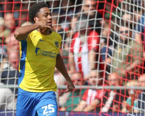Ryan Kavuma-McQueen phones a friend after opening the scoring for Portsmouth against Lincoln City.
