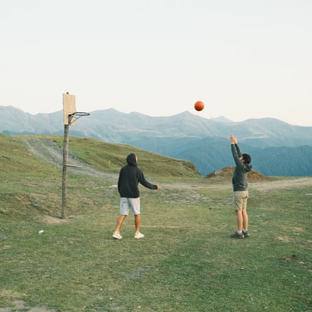 Two man playing basketball, near the entrance road of upper Omalo