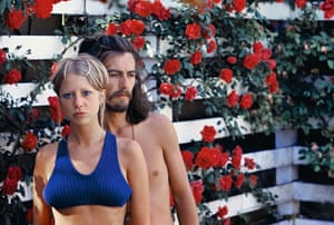 George Harrison &amp; Pattie in Rose Garden, 1968‘’Putting my camera on a tripod I wanted to capture the roses in bloom. A willing model, George, and I stood waiting for the shutter to click... he impatiently looked away and I looked worried! If I had known this photo would have become so popular I might have fixed my hair!’’
