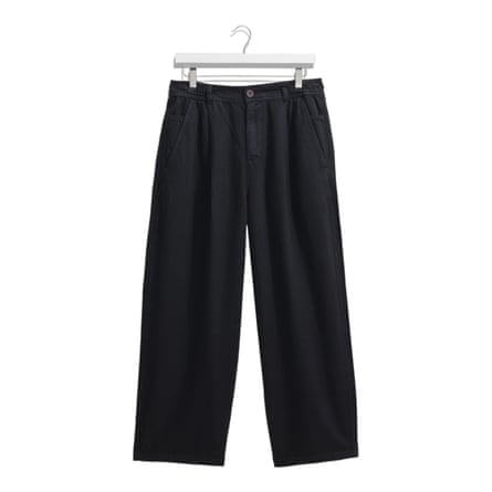 Navy carpenter trousers on a white hanger on a background