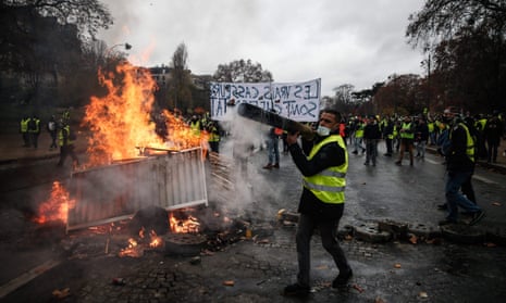 Yellow vests build a barricade during a protest against rising oil prices and living costs.
