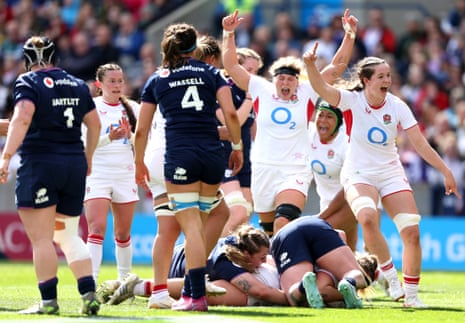 England's Kelsey Clifford (hidden) scores their side's fourth try of the game as team-mates celebrate.