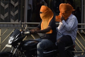 Commuters cover their faces in Amritsar, India