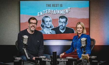 Richard Osman and Marina Hyde sitting in a recording studio with a graphic of their podcast in the background.