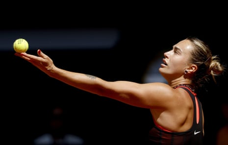 Aryna Sabalenka tosses the ball to serve