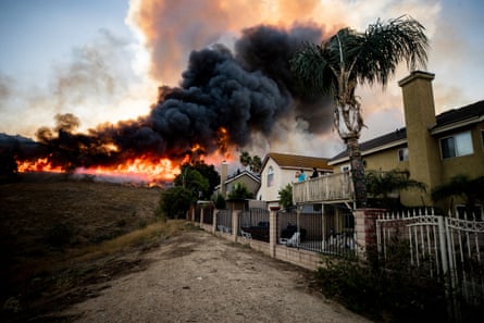 Residents watch flames from the Blue Ridge fire creep closer to their homes on 27 October in Butterfield Ranch, California.