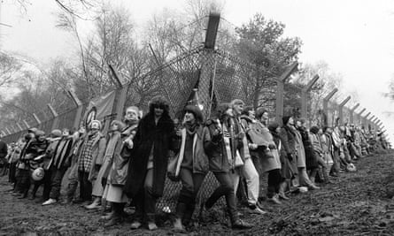 Women from the Greenham Common peace camp chain in 198