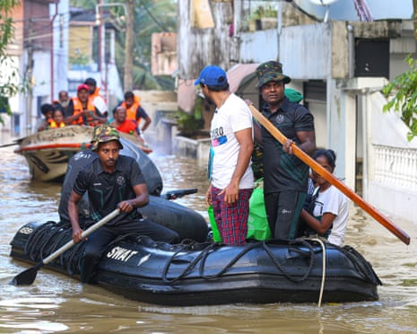 Sri Lankan special task force soldiers rescue residents from flood-affected areas after heavy rains from Cyclone Ditwah sweep through Colombo.