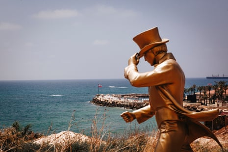 A gold Johnnie Walker promotional statue overlooks a sea-side resort on the outskirts of Batroun on 15 July, 2020.