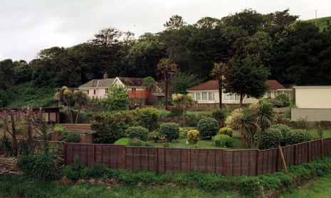 Two bungalows on a hill behind a wooden fence in Saunton, north Devon