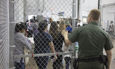 Border Patrol agents process migrants who crossed the border a facility in McAllen, Texas on 17 June. 