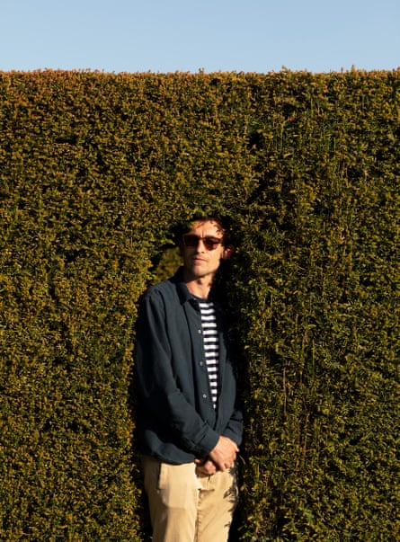 Oscar Quine standing in a hole in a hedge