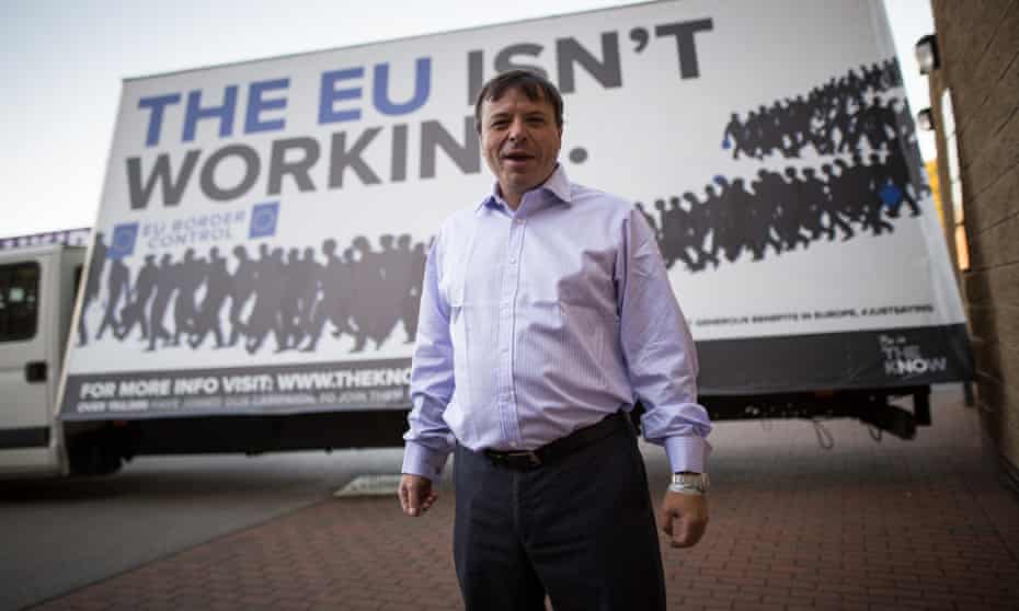 Aaron Banks, the founder of Leave.EU, in front of anti-EU poster