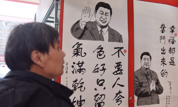 A man looks at a poster quoting the thoughts of President Xi Jinping, in Beijing.