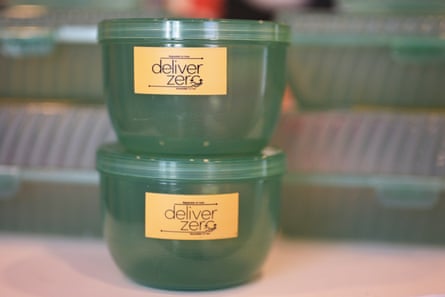 Two reusable plastic containers with the DeliverZero label.