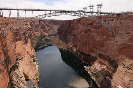 Power lines hang over the Colorado River, from a bridge connecting two sides of the canyon