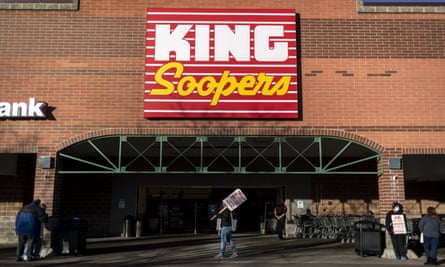 Union workers hold signs during a strike outside a King Soopers grocery store location in Westminster, Colorado on Wednesday.
