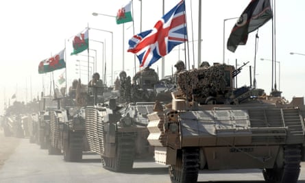 A convoy of British armoured vehicles patrol a road after pulling out from Basra Palace in September 2007.