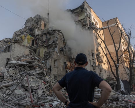A man looks at a residential building damaged following a Russian air attack on the Ukrainian capital of Kyiv.