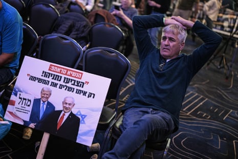 A supporter of the Likud party waits at an election night rally in Jerusalem.