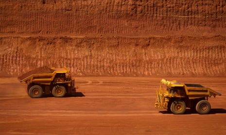 trucks on red earth on a mining operation in the pilbara