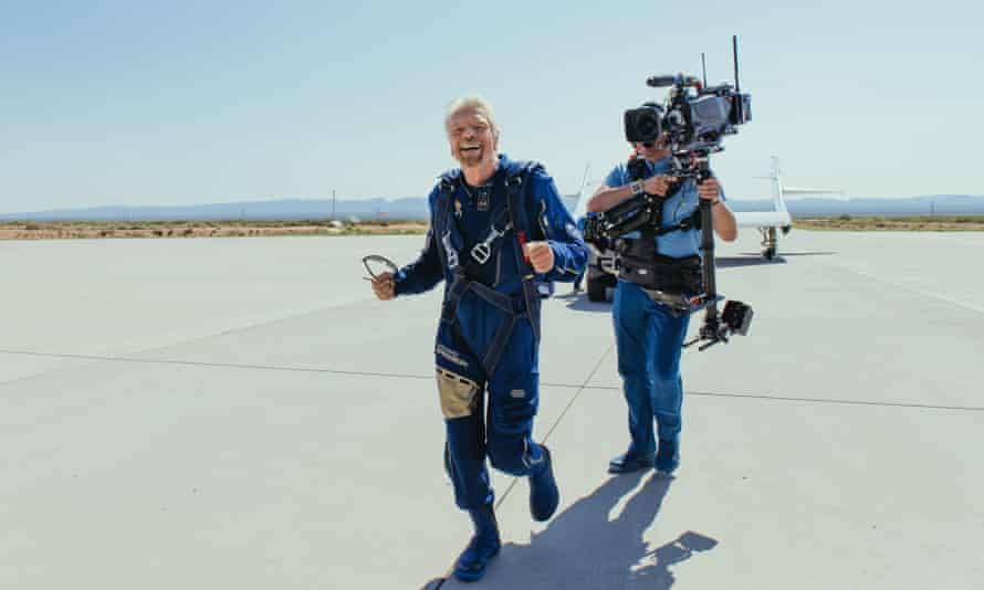 Smile for the cameras … Branson after Unity lands safely.