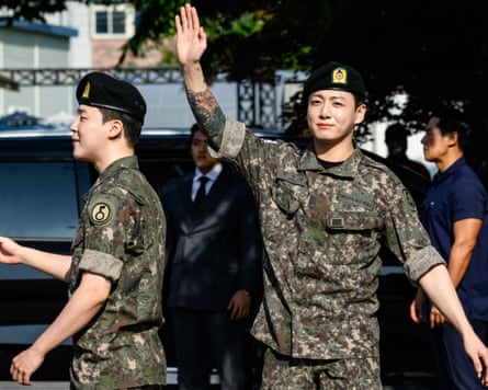 Jimin (left) and Jungkook wave as they depart from an outdoor sporting facility in Yeoncheon in June 2025, shortly after their release from 18 months military service.