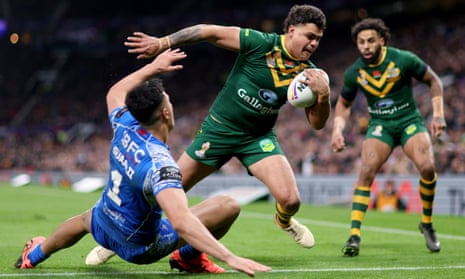 Australia's Latrell Mitchell beats Samoa's Josh Sawali on the way to score his team's first try.