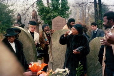 Mourners gather among gravestones at a cemetery in Kensal Rise, 1988