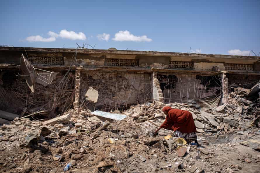 A woman picks through fire-damaged remains at Waheen market in Hargeisa.