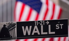 A Wall Street with a US flag in the background
