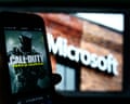 An image from Activision's Call of Duty is shown on a smartphone near a photograph of the Microsoft logo in this photo taken in New York, Thursday, June 15, 2023. A judge handed Microsoft a big victory on Tuesday, declining to stop its $69 billion takeover of video game maker Activision Blizzard.