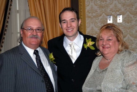 two men and a woman in formal wear smile together