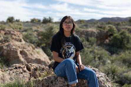 Naelyn Pike seated outdoors on rock formation
